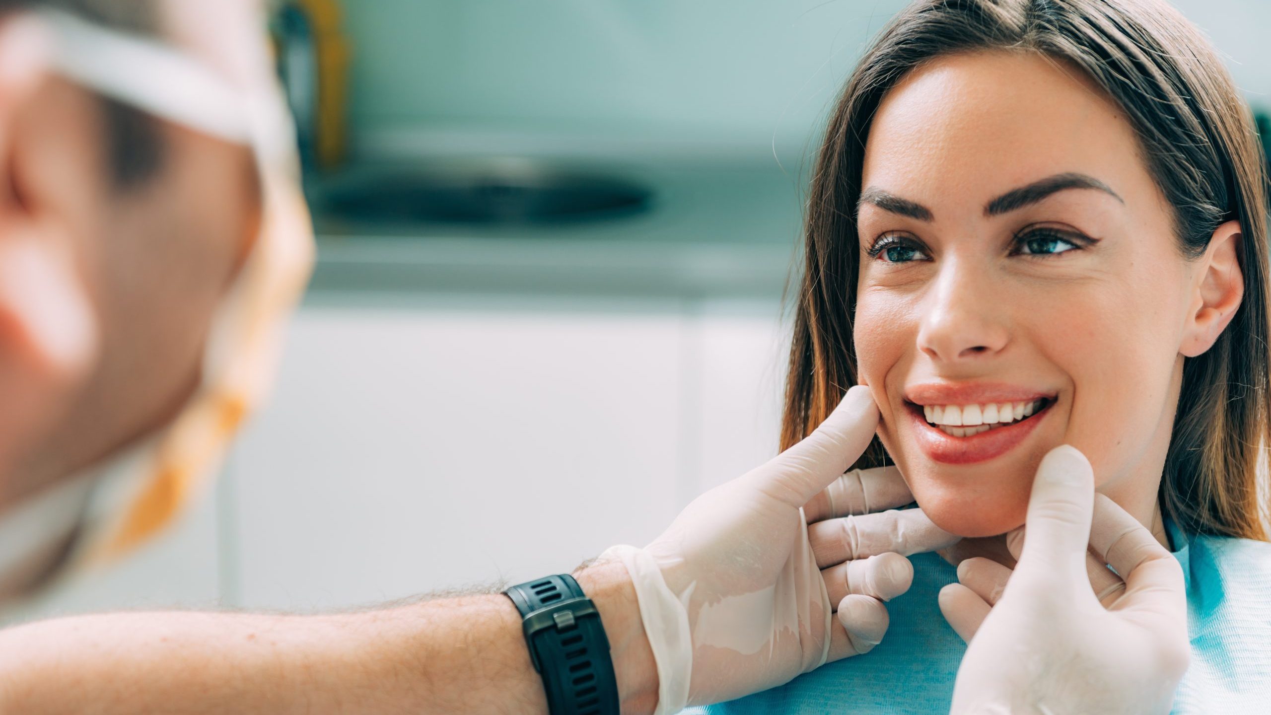 Dentist with beautiful female patient Young smiling woman with beautifiul teeth, having a dental inspection